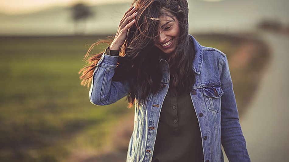 mujer pelo largo al viento con cazadora vaquera