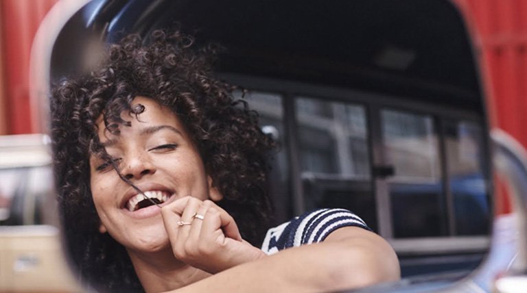 chica morena pelo rizado en coche