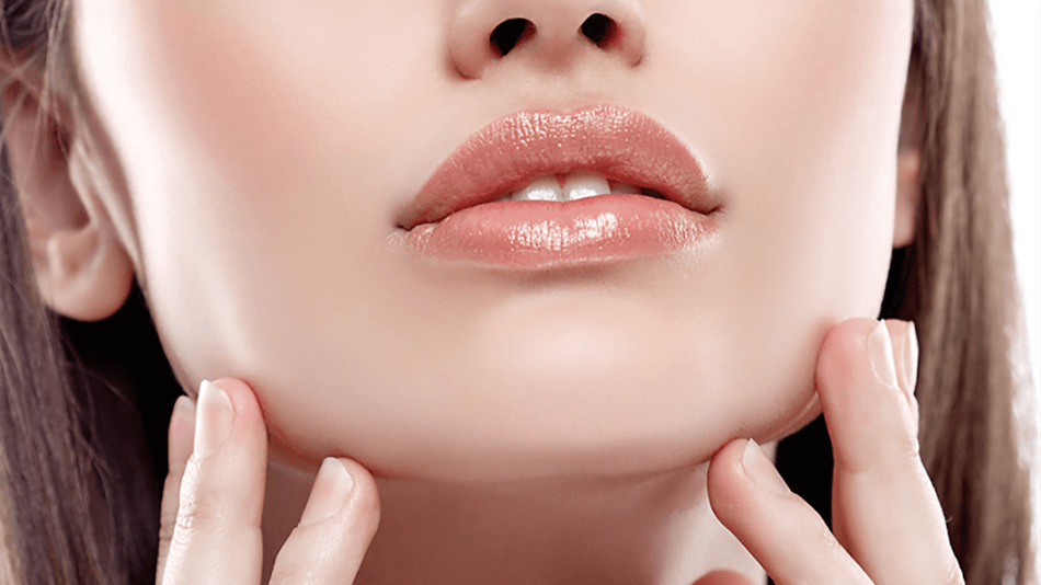 Rostro inferior de chica tocandose la cara con las manos